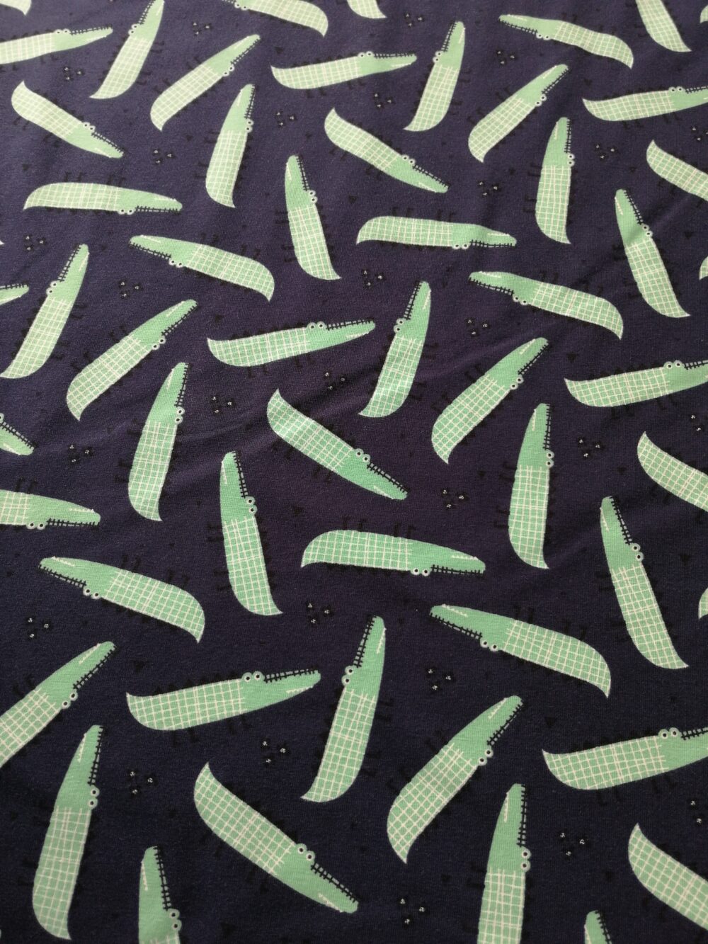 crocodiles on navy cotton jersey fabric by the half metre