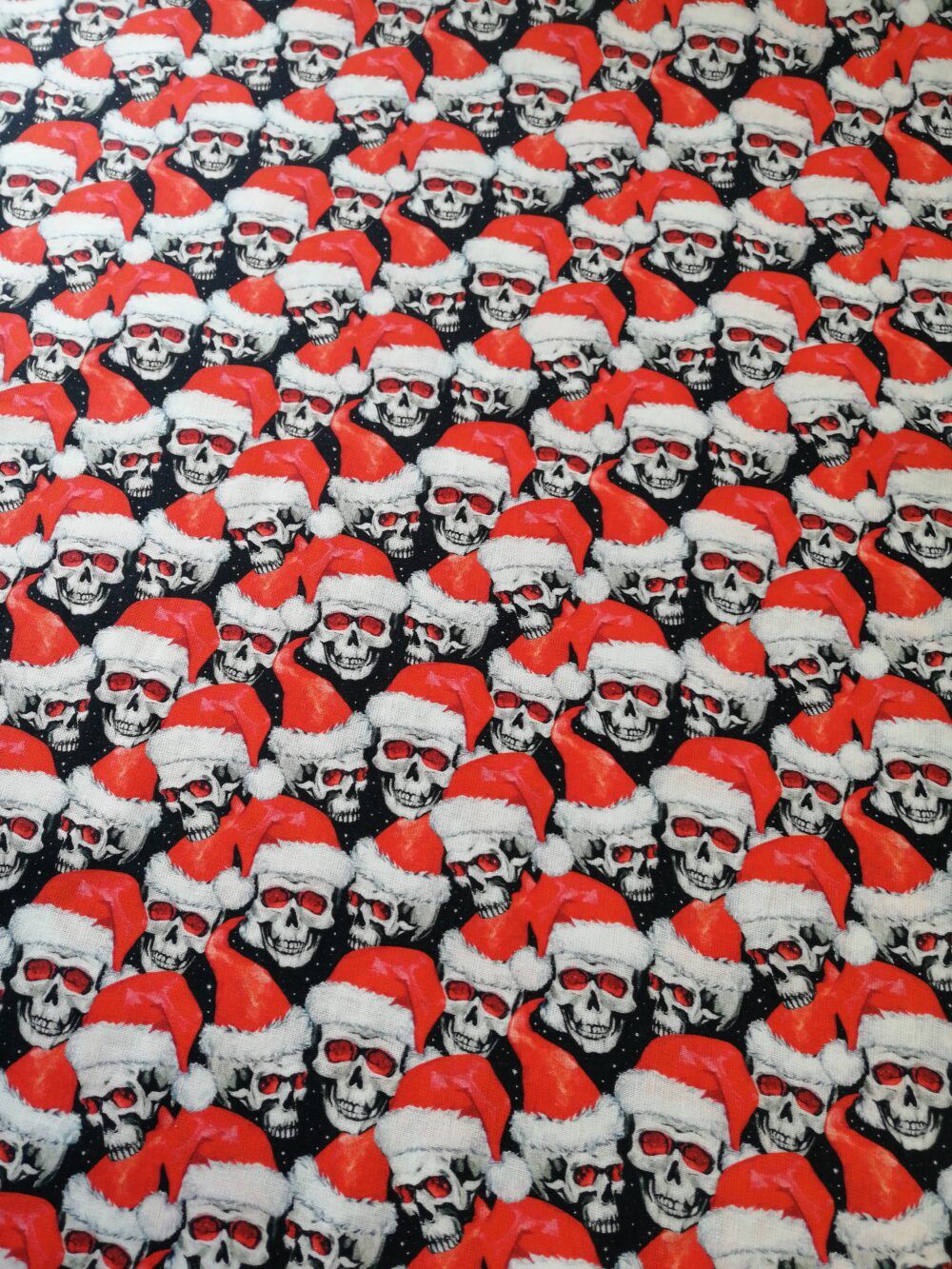 Skulls with Santa hats cotton fabric by the half metre