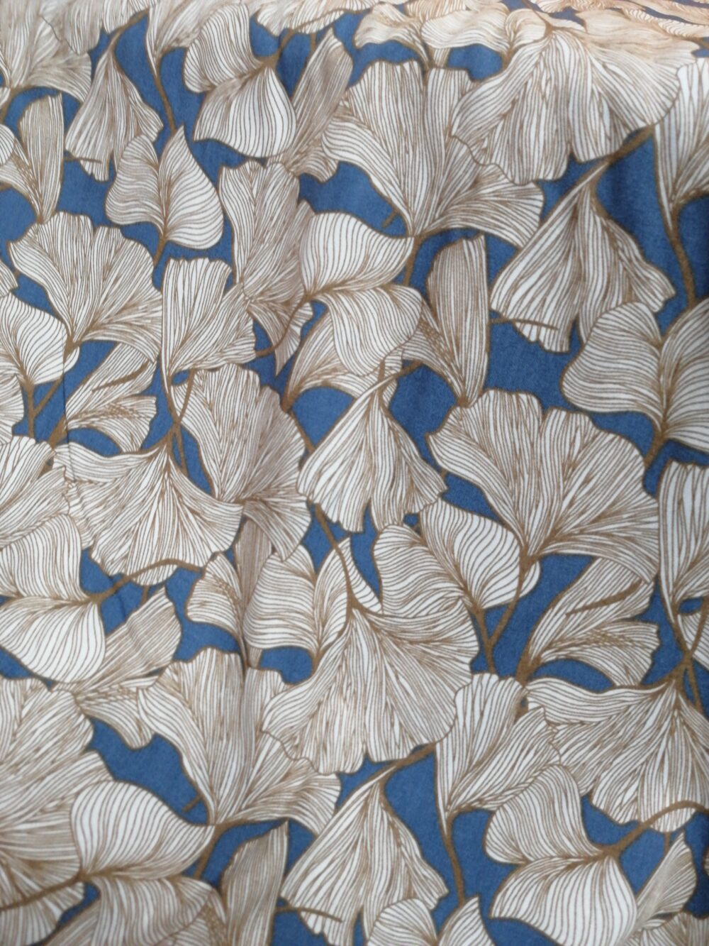 Ginkgo leaves on blue viscose fabric